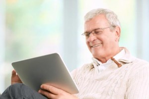 Older man reading on a tablet